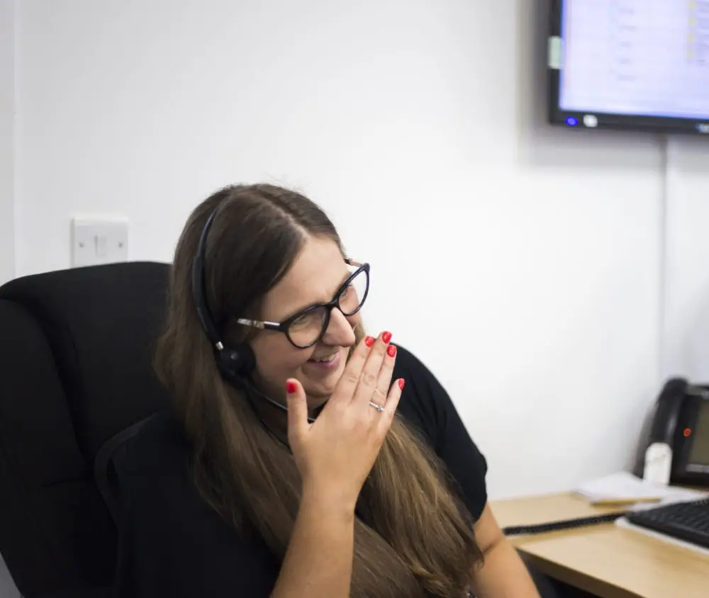 A member of Face For Business' call answering team laughing