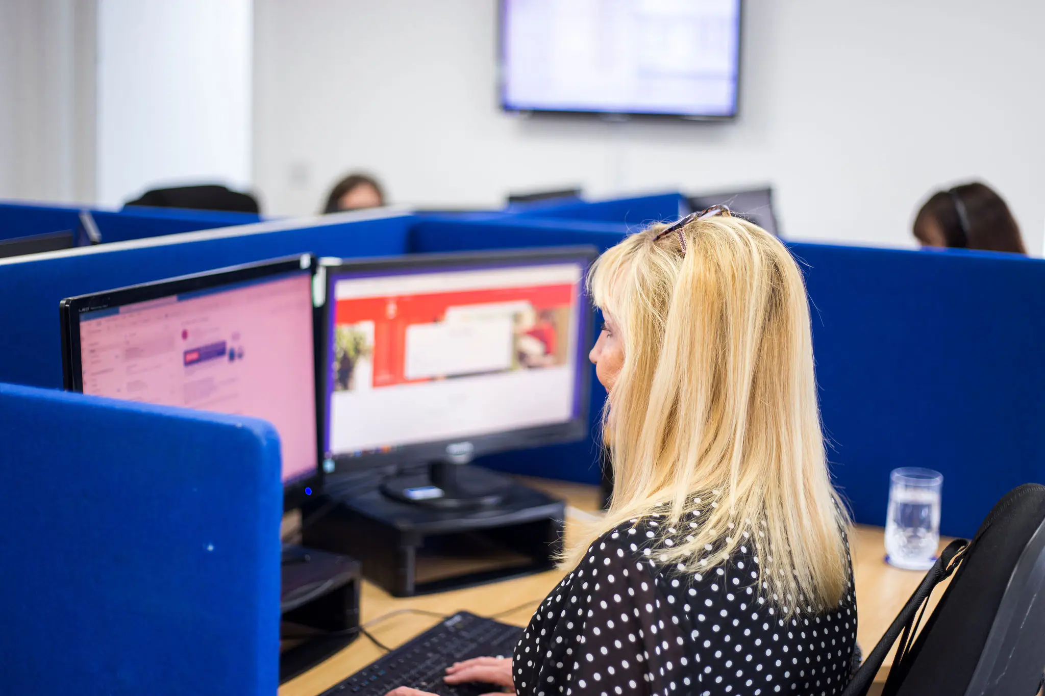 A call handling service PA viewing two screens while taking a call