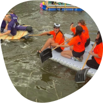 Face For Business competing in a charity raft race
